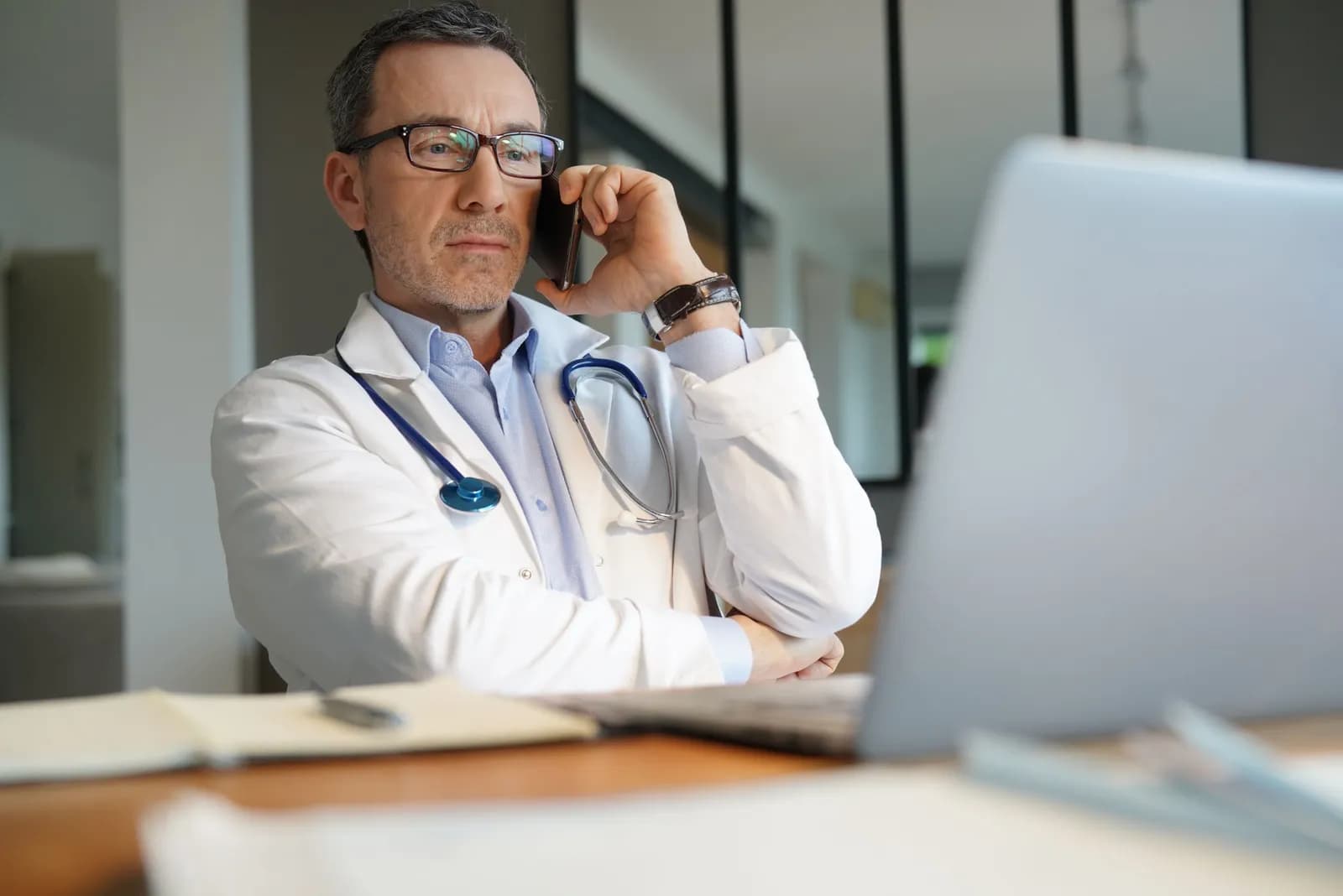 Radiologist on the phone at a laptop