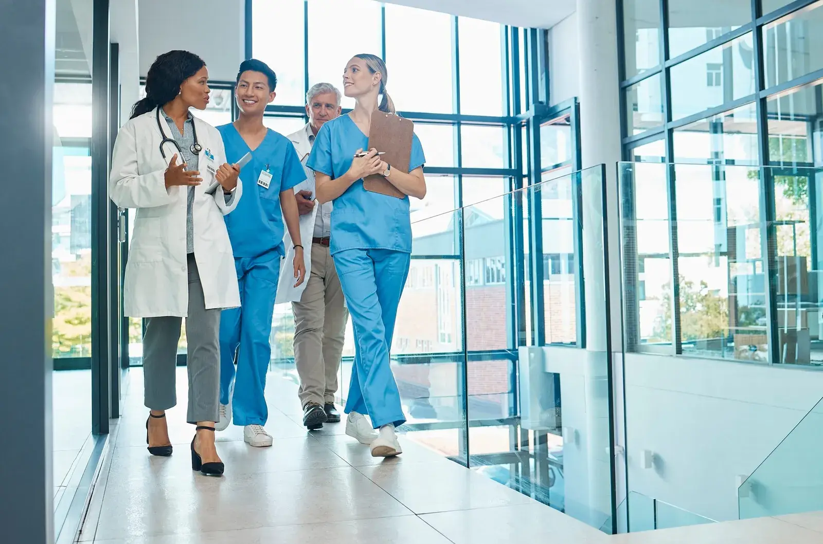 Team of physicians and clinicians walking together in a hospital